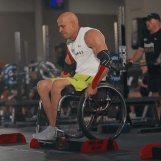wheelchair athlete simulating a curb in competition
