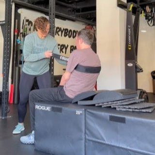 Jenna with Fit To Function Recovery using the Equip Products Body Strap to do assisted sit ups