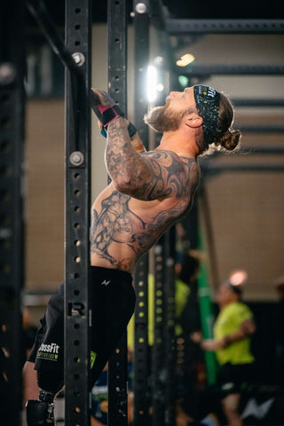 Male Amputee doing a pull up on a rig