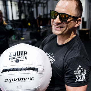 A Visually Impaired Man holding an Equip - Dynamax White Wall ball.