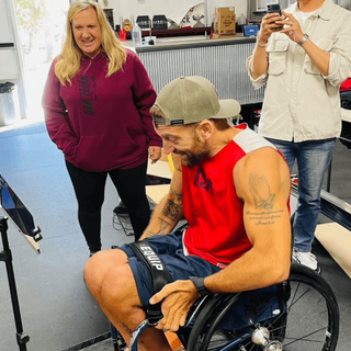 Chuck Melton using the Leg Strap sitting in his everyday wheelchair after therapy - him crushing it