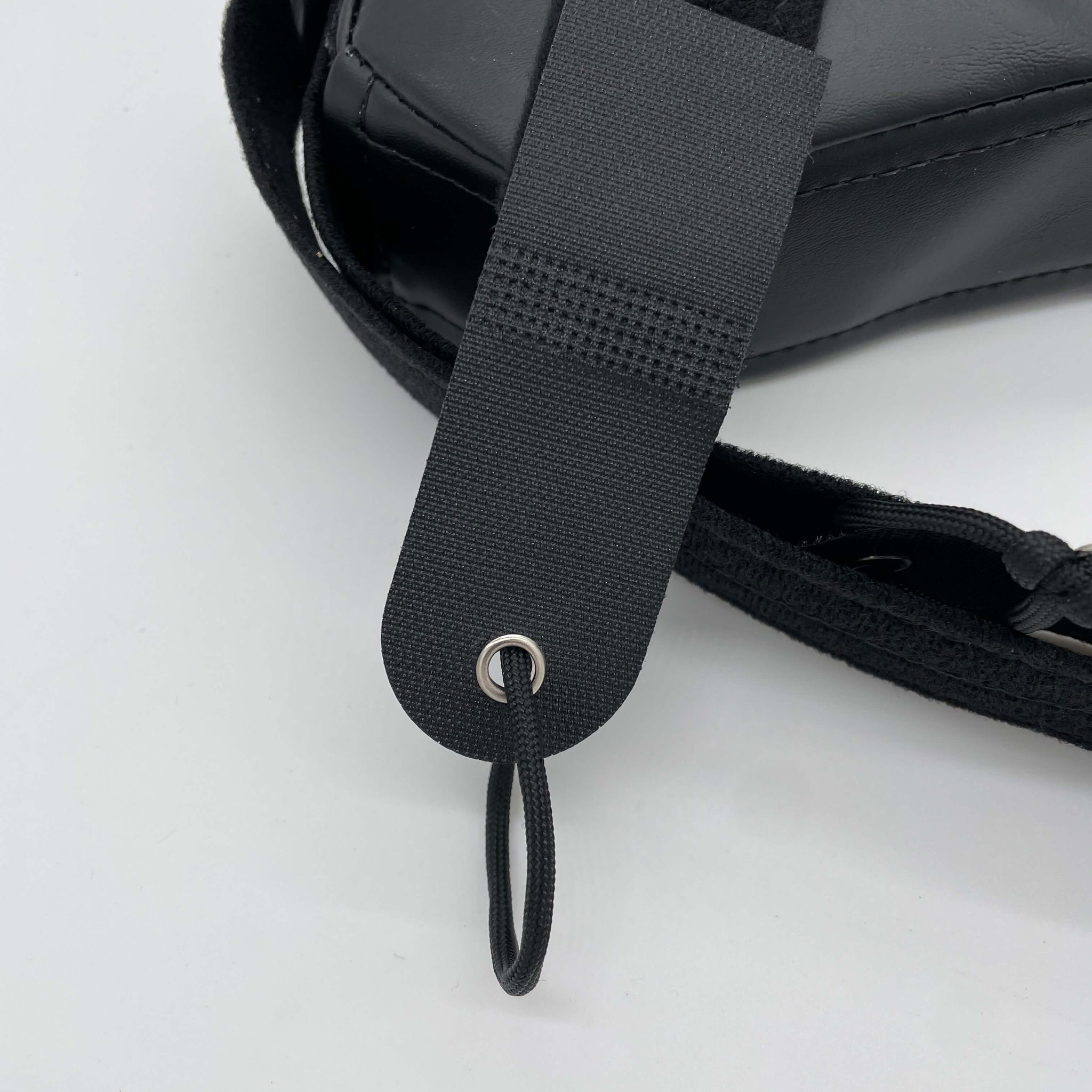 A grommet and loop in the end of a strap for quads to hook their thumb using a LapMat™