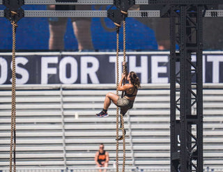 Amy Bream, CrossFit Athlete and Adaptive Superstar climbing a rope during the 2023 CrossFit Games in Madison Wisconsin.