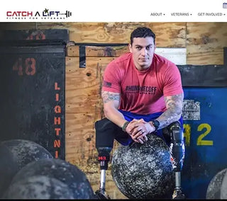 Sgt. Jason Smith of Catch A Lift Fund sitting on Atlas Stone with prosthetics.
