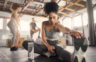 Attractive women stretching on the floor of a gym