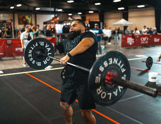 Man lifting a barbell with one arm, missing the right arm