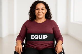 Woman in wheelchair using an Equip Body Strap - Wheelchair Strap