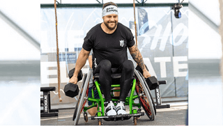 Jedidiah Snelson doing kettle bell deadlifts in his sports chair.