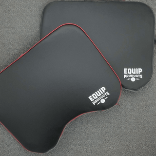 Two Equip Products HandyMat™ one all Black, the other with a red highlight on a gym floor