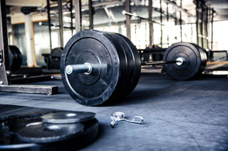 Loaded barbell on a empty gym floor 