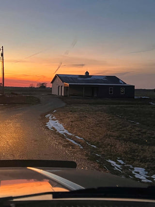 The Equip Products renovated horse barn at sunset with traces on snow on the ground