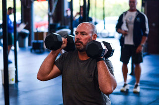 Older man doing rehabiliation in a gym setting