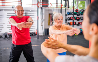 Older couple working out together in a gym