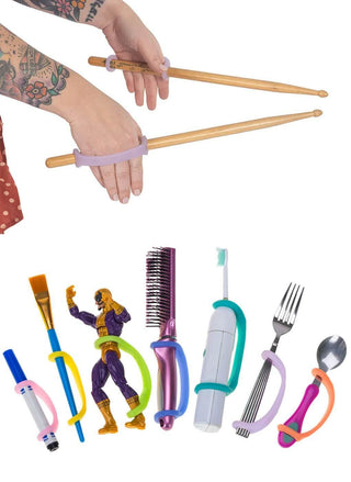 Hands using EazyHold Teacher & Therapist 7-Pack with various utensils and toys, showcasing secure grip aids.