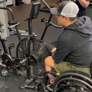 Equip Products Adaptive Bike Handles for The Assault Bike being used by a wheelchair user