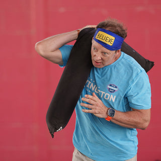 Man Carrying the Equip Products CrossCarry Sandbag doing sprints