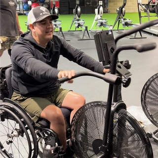 Man using a stationary bike in a gym setting