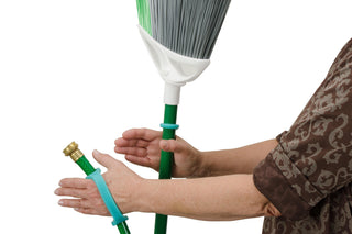 Image of hands using EazyHold Teacher & Therapist 7-Pack universal cuff grip aids with a broom and hose.