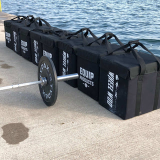 Seven Equip Products Packages lined up on a dock at the 2019 WheelWOD Games Debut in Collinwood, Canada