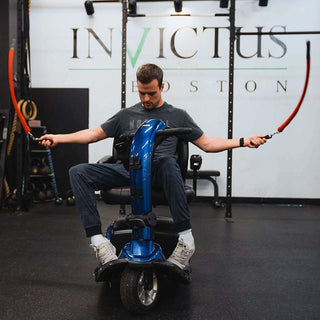 Man in a powered wheelchair using Multi Ropes™ (Jump Ropes For Seated Athletes.)