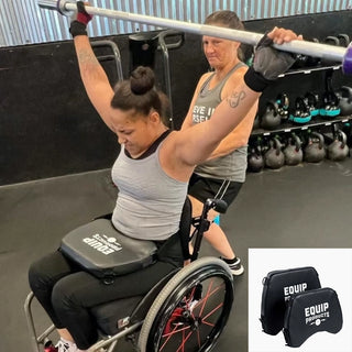 Lady in wheelchair, barbell overhead, and using a LapMat