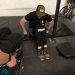 Leg Strap on Wheelchair user working on floor