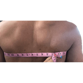 Male body being measured for the Aldridge Arm Harness, back image
