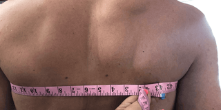 Male body bieng measured for the Aldridge Arm Harness, back image