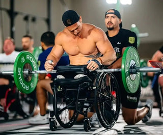 Athlete in a wheelchair lifting weights with LapMat™ Protecting His Legs