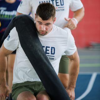 Tom Miazga Carrying an 80 Pound CrossCarry Sandbag by Equip Products