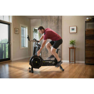 Lifestyle picture of a man in a room using the Concept2 Bike Erg