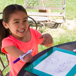 EazyHold Teacher & Therapist 7-Pack being used by a girl drawing with a marker, showcasing colorful grip aids.