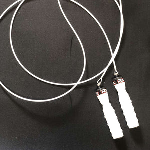 White jump rope and handles on a black floor, curled in a round or looping pattern, with Rx Smart Gear showing on the cable end of the handles, by Equip Products