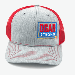 Trucker hat in red mesh - grey front panel with the Ogar Strong Logo embroidered on the front left panel
