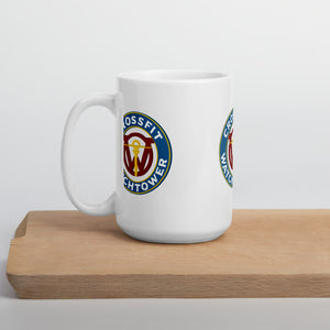 CrossFit Watchtower Coffee Mug sitting on a wood table handle turned toward the left